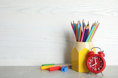 Photo of Different school stationery on table against light background