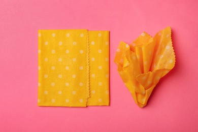 Photo of Beeswax food wraps on pink background, flat lay