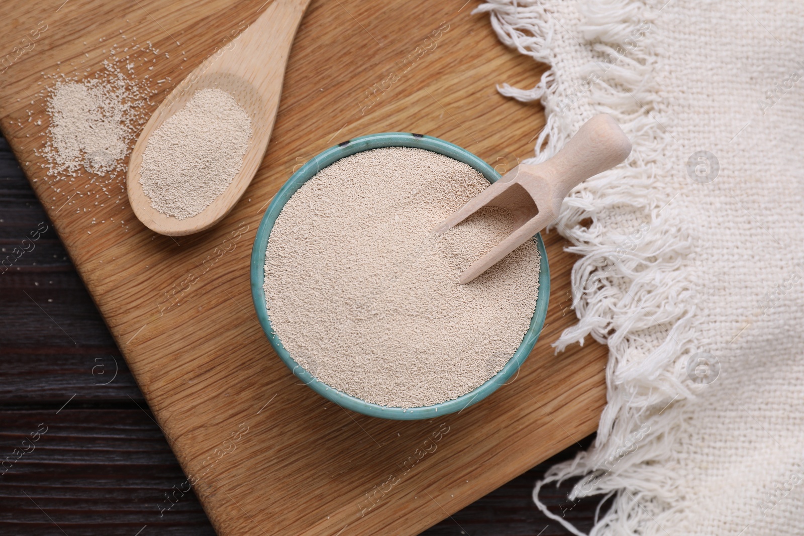 Photo of Active dry yeast on wooden table, top view