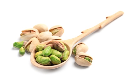 Photo of Organic pistachio nuts and spoon on white background, closeup