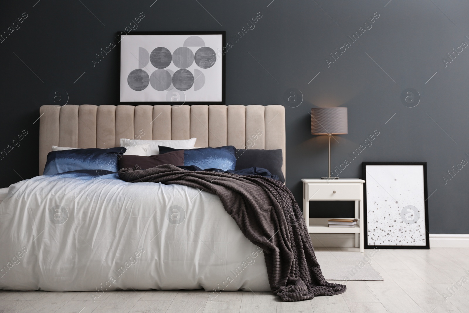 Photo of Comfortable bed with pillows and soft blanket in room. Stylish interior design