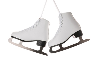 Photo of Pair of figure ice skates hanging on white background