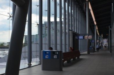Photo of Blurred view of waiting benches near big glass windows indoors