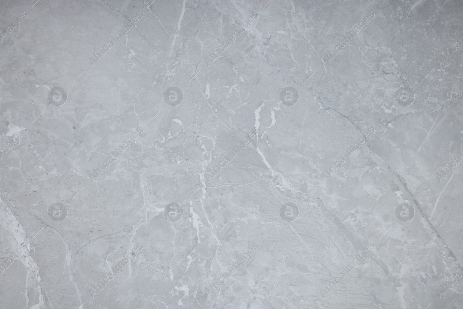 Photo of Texture of light grey marble surface as background, closeup