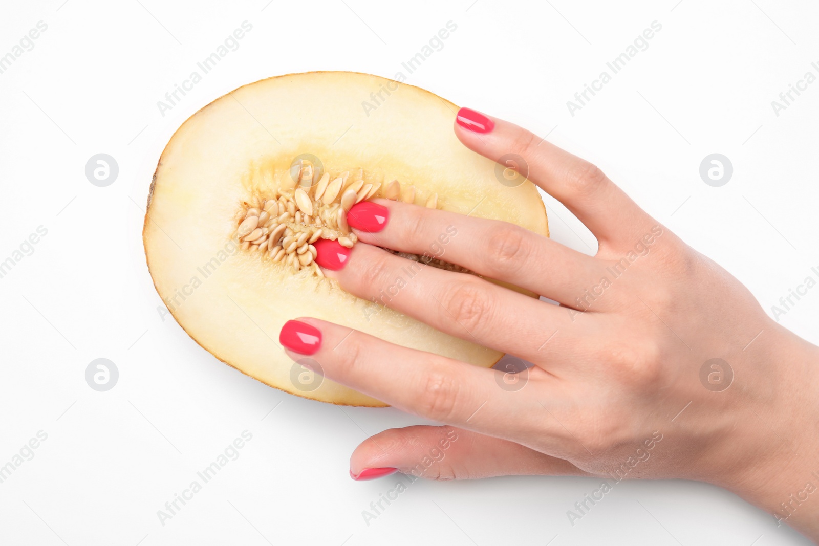 Photo of Young woman touching half of melon on white background, top view. Sex concept