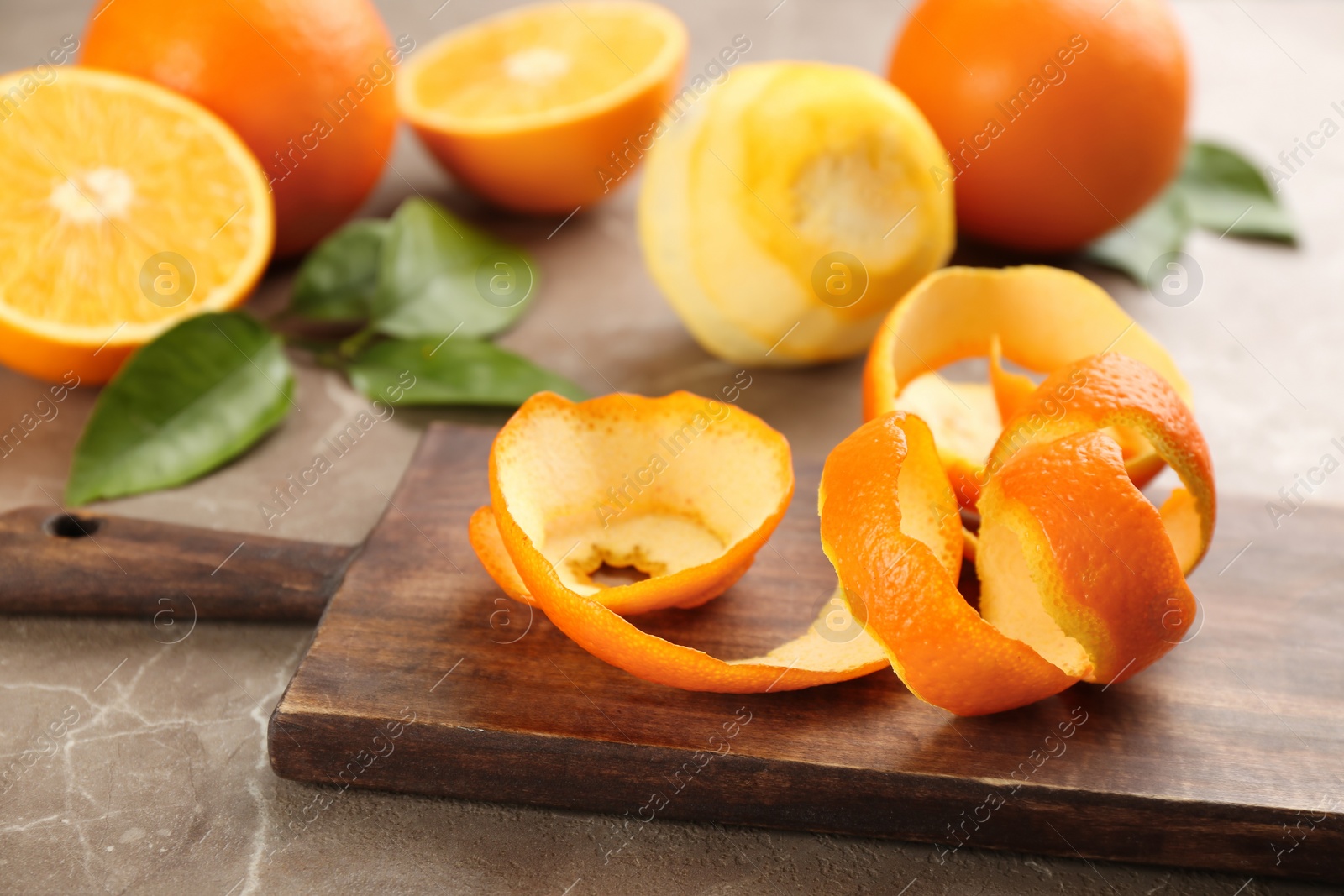 Photo of Orange fruit peel on grey marble table