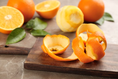 Photo of Orange fruit peel on grey marble table