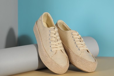 Photo of Pair of stylish sneakers on color background