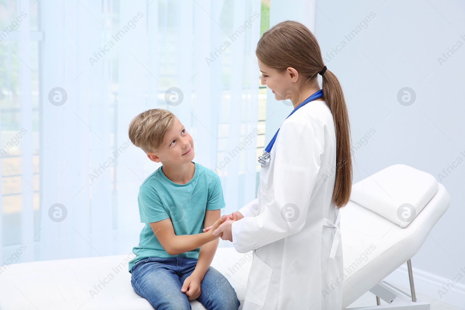 Photo of Doctor checking little boy's pulse in hospital