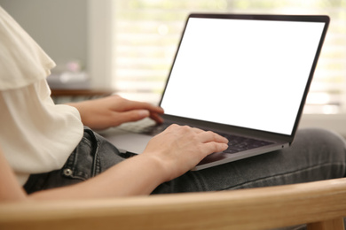 Photo of Woman working with modern laptop indoors, closeup