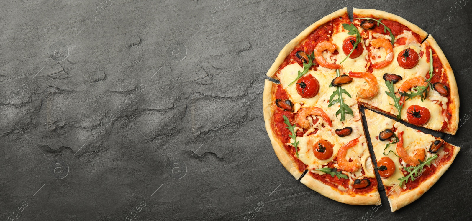 Image of Top view of hot delicious pizza on dark table, space for text. Banner design 