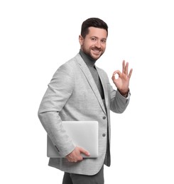 Handsome bearded businessman with tablet showing OK gesture on white background