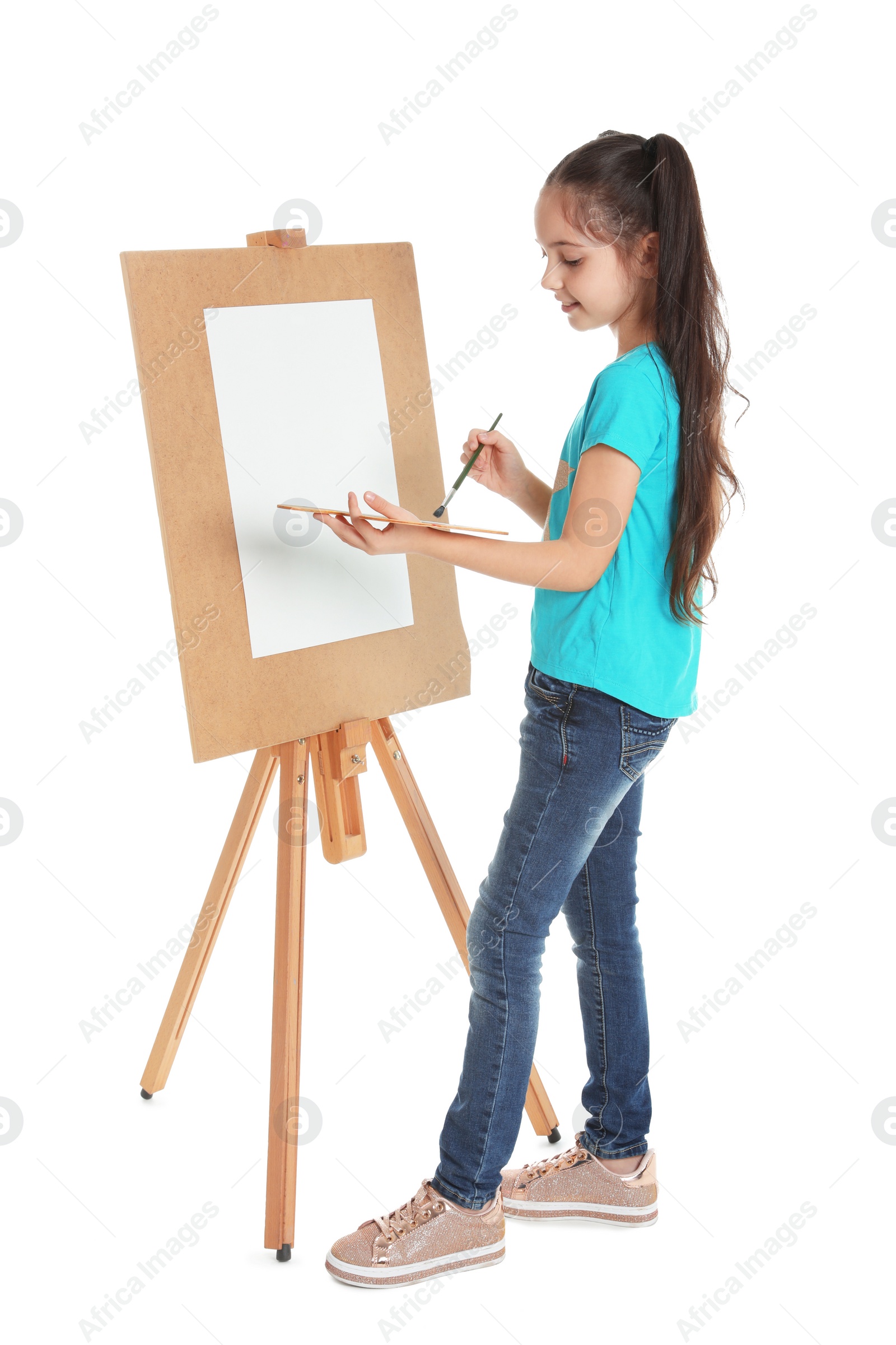 Photo of Child painting picture on easel against white background. Space for text