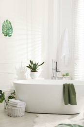 Photo of Stylish bathroom interior with green plants. Home design