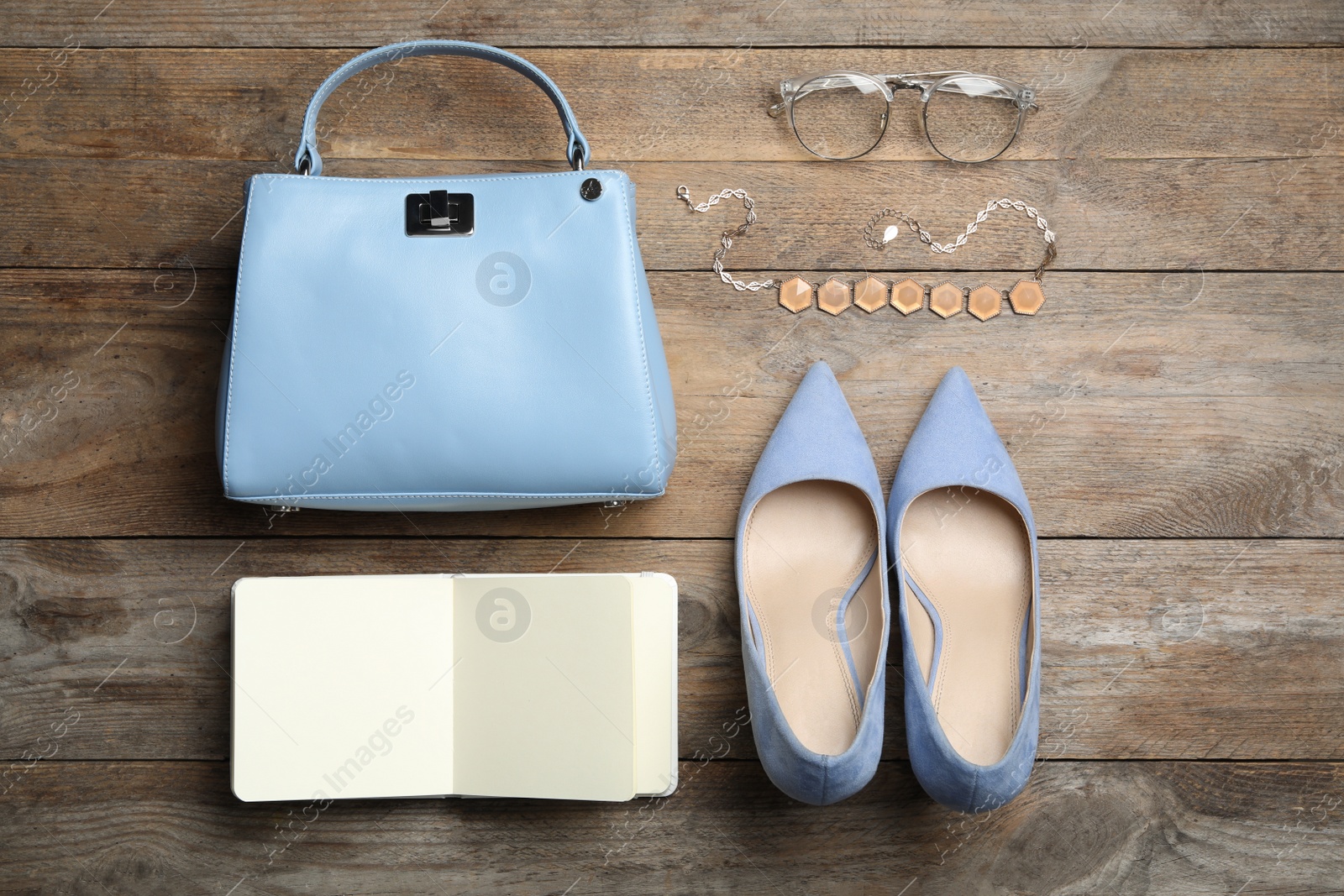 Photo of Stylish shoes, small woman's bag and accessories on wooden background, flat lay