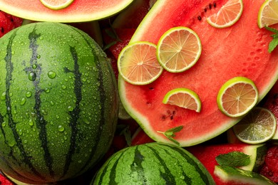 Juicy watermelon with lime and mint as background, top view