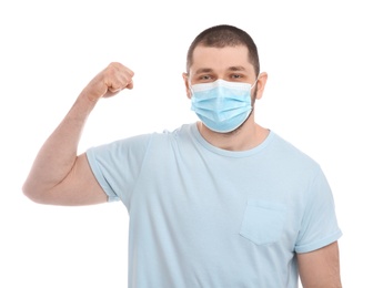 Photo of Man with protective mask showing muscles on white background. Strong immunity concept