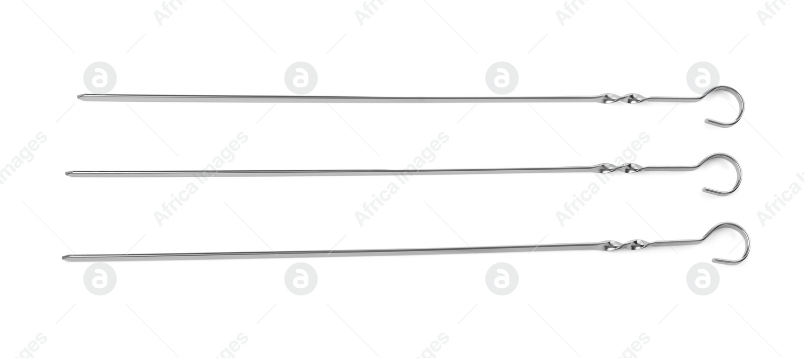 Photo of Metal skewers on white background, top view. Barbecue utensil