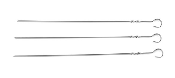 Photo of Metal skewers on white background, top view. Barbecue utensil