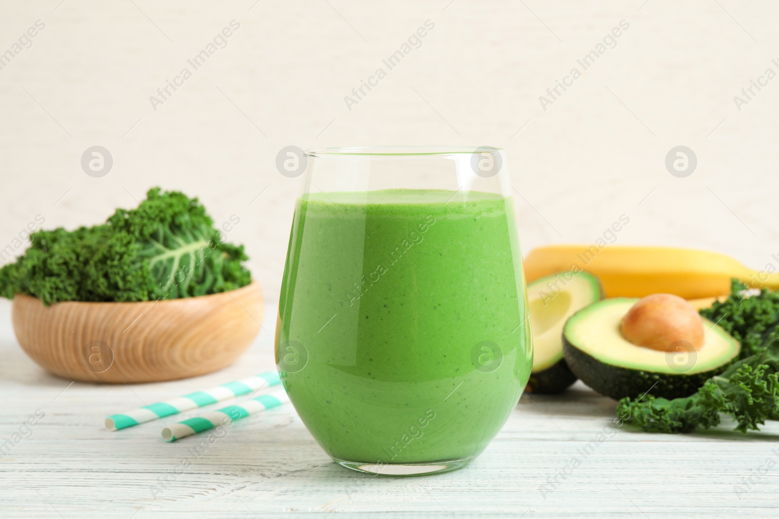 Photo of Tasty fresh kale smoothie on white wooden table