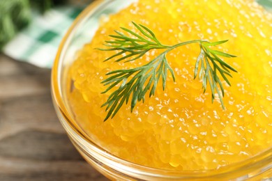 Fresh pike caviar in bowl on wooden table, closeup