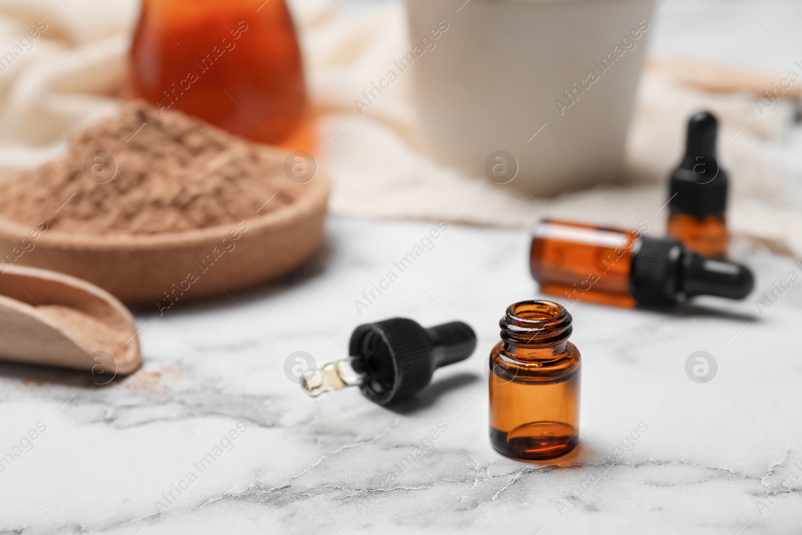 Photo of Closeup of bottle with cinnamon oil on light table