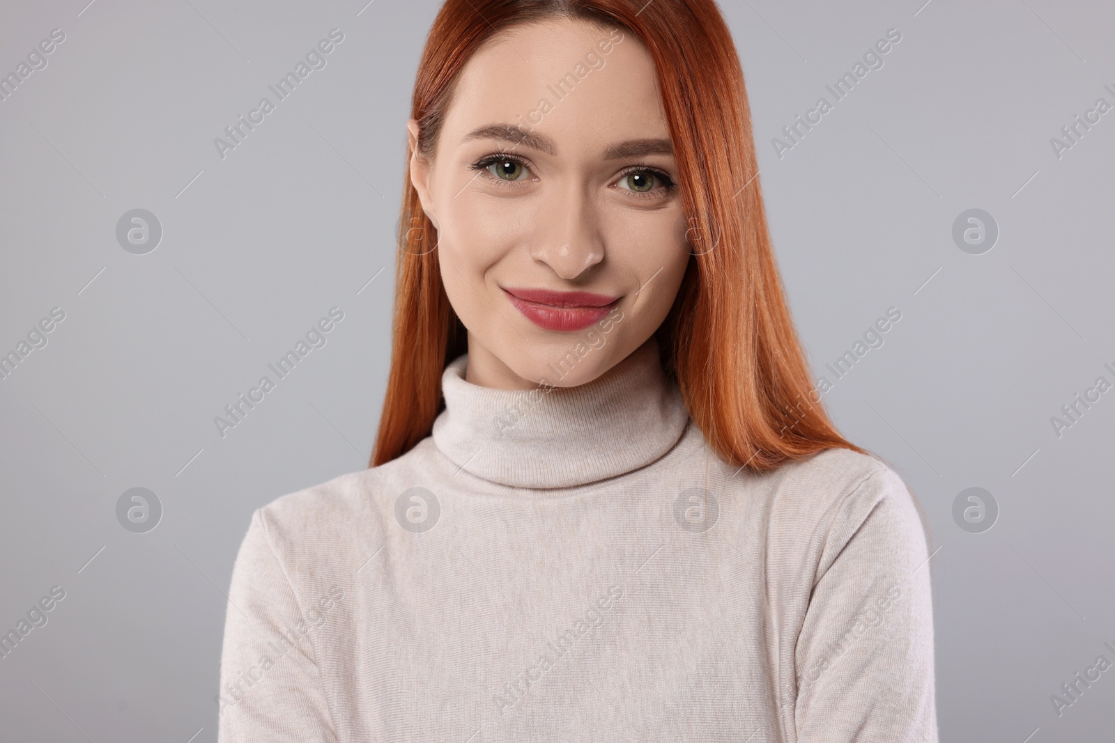 Photo of Portrait of beautiful young woman on light gray background