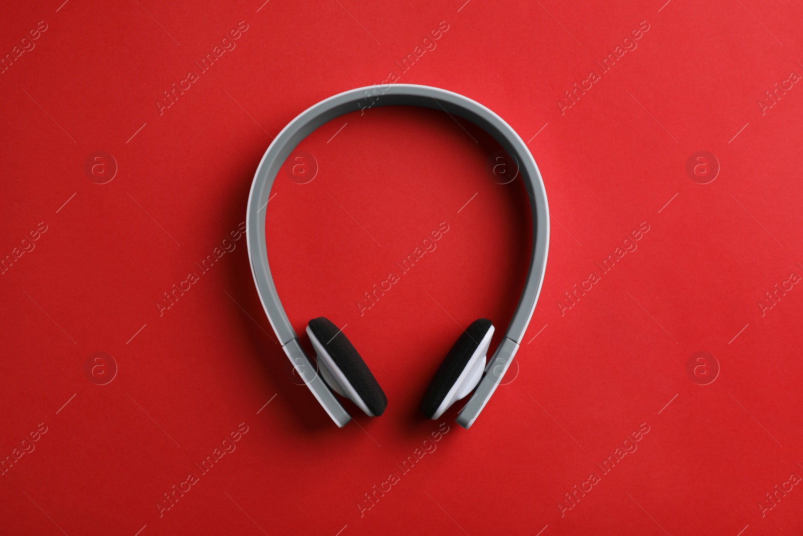 Photo of Wireless headphones on color background, top view