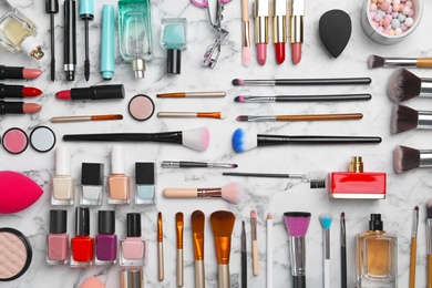 Photo of Flat lay composition with cosmetic products on marble background