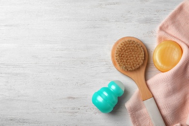 Photo of Flat lay composition with deodorant, brush and soap on wooden background