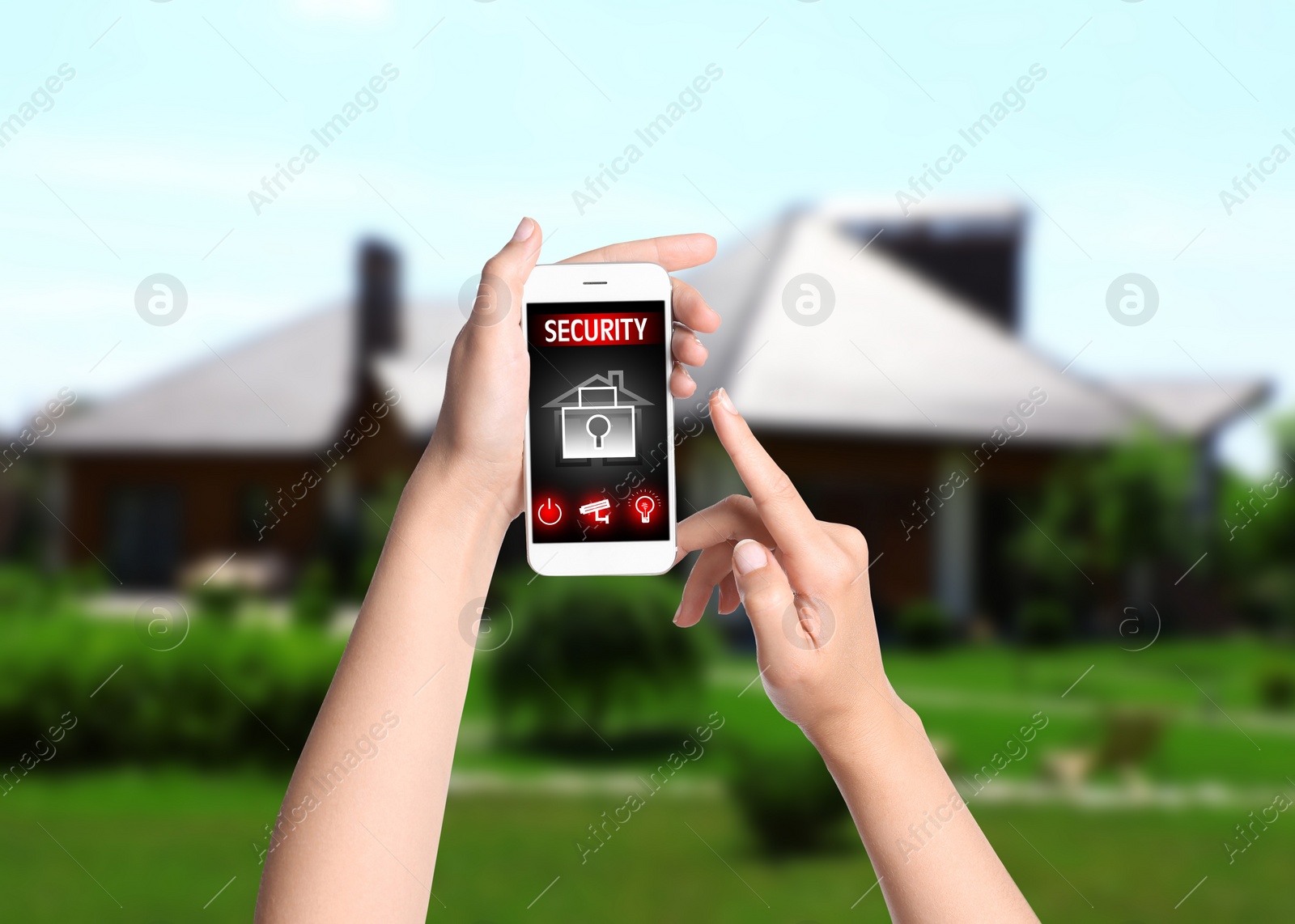 Image of Woman monitoring modern CCTV cameras on smartphone near her house, closeup. Home security system