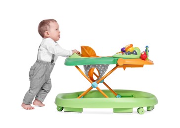 Photo of Cute little boy with baby walker on white background