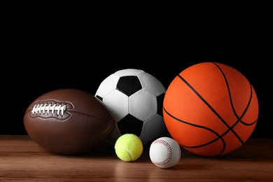 Set of different sport balls on wooden surface