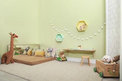 Montessori bedroom interior with floor bed and toys