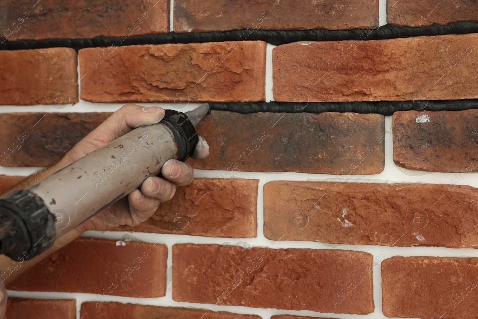 Photo of Professional builder using tiling fugue for grouting, closeup