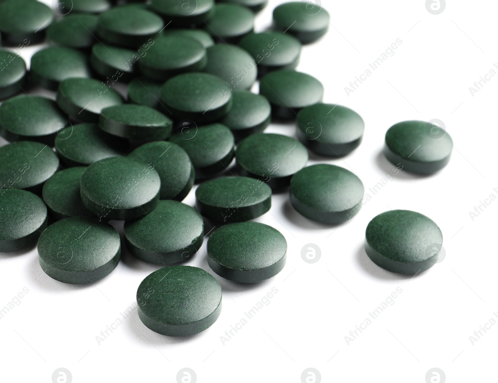 Photo of Spirulina tablets on white background. Healthy lifestyle