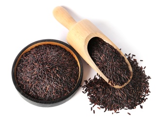 Photo of Plate and scoop with uncooked black rice on white background