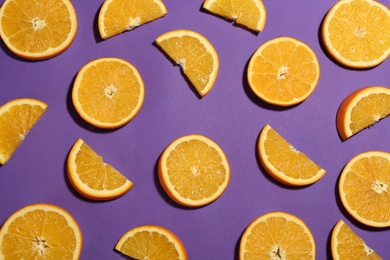 Photo of Flat lay composition with fresh ripe oranges on purple background