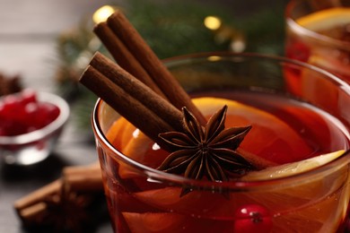 Photo of Glass with delicious punch drink on table, closeup