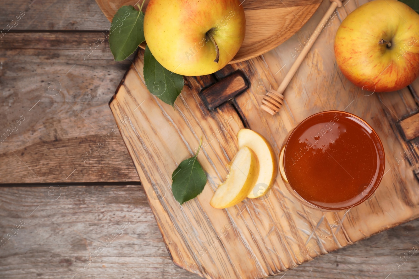 Photo of Flat lay composition with glass of honey, apples and dipper on wooden table