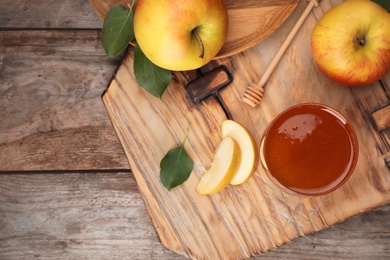 Photo of Flat lay composition with glass of honey, apples and dipper on wooden table