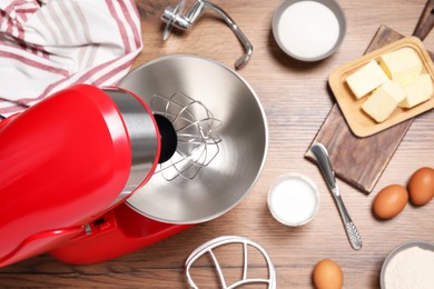 Photo of Red stand mixer and different ingredients on wooden table, flat lay