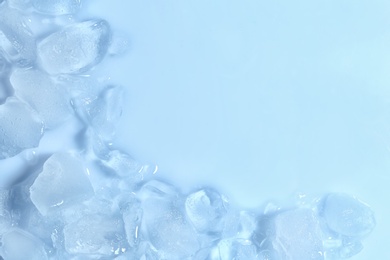 Photo of Melting ice cubes on color background, top view. Space for text