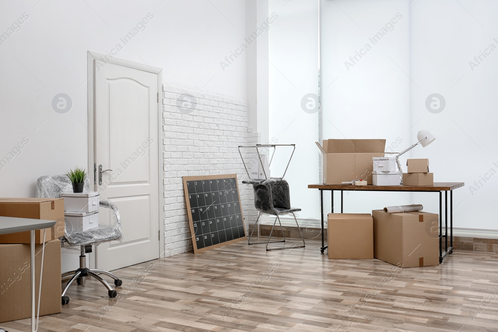 Photo of Moving boxes and furniture in new office