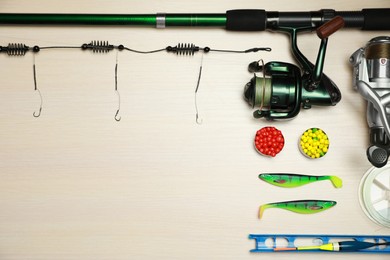 Fishing tackle on wooden background, flat lay. Space for text