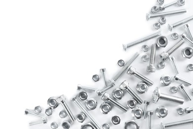Photo of Different metal bolts and nuts on white background, top view