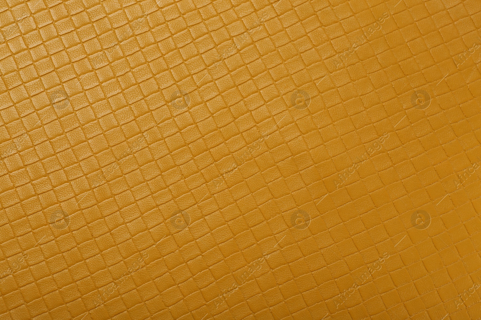 Photo of Beautiful yellow leather as background, top view