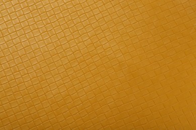 Photo of Beautiful yellow leather as background, top view