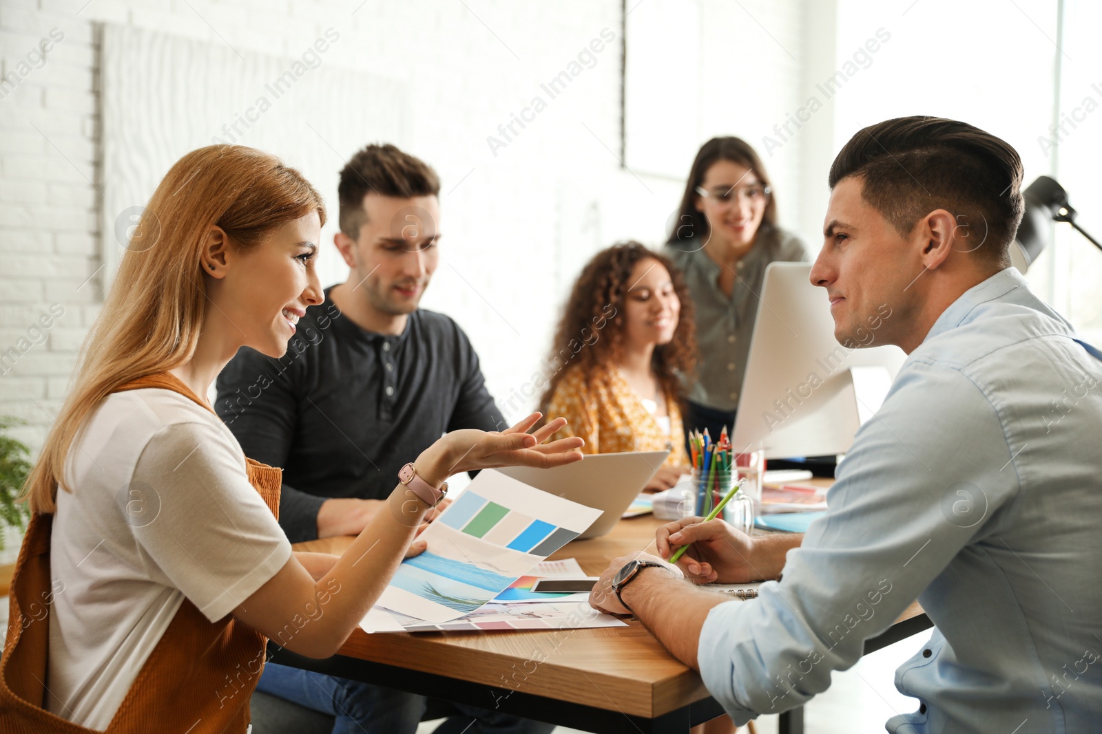 Photo of Team of professional designers working in office