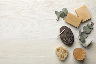 Flat lay composition with pumice stone on white wooden background. Space for text